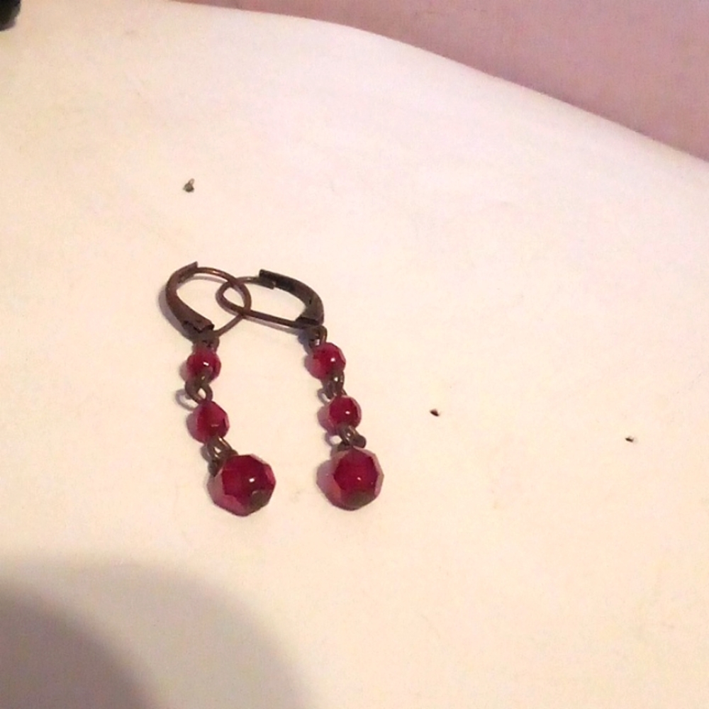 Black earrings with red beads